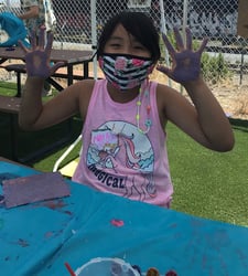 Camper with paint on her hands